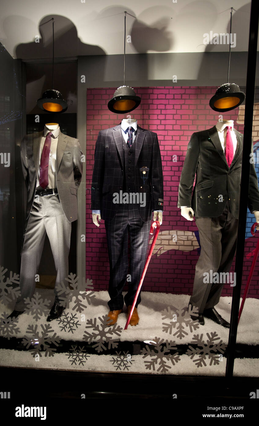 Fashion shop window displaying headless mannequins with hats, wearing the winter collection, London, England, 2011 Stock Photo