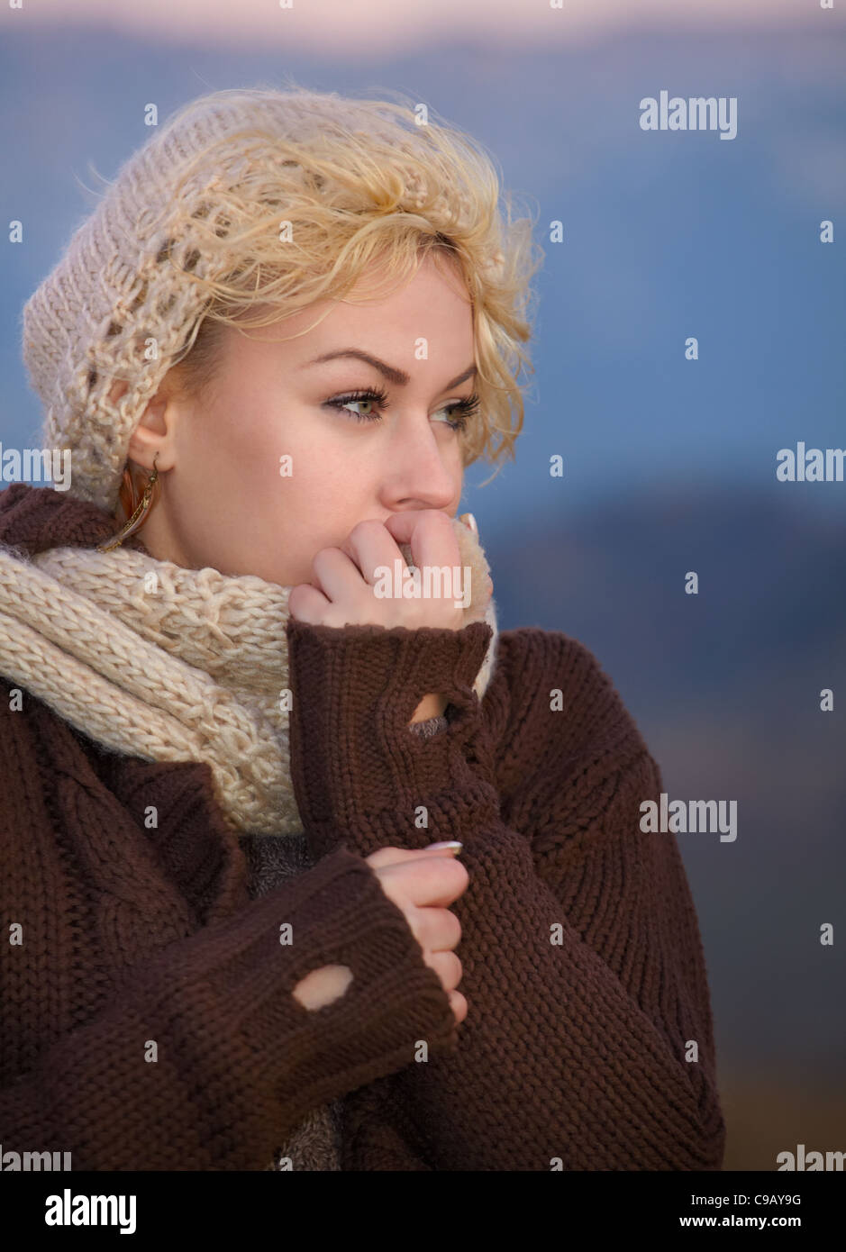 Portrait of a young woman as evening falls in autumn cold. Stock Photo