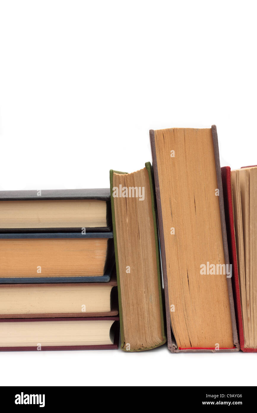 Stacked hardback books, both old and new, with a white background Stock