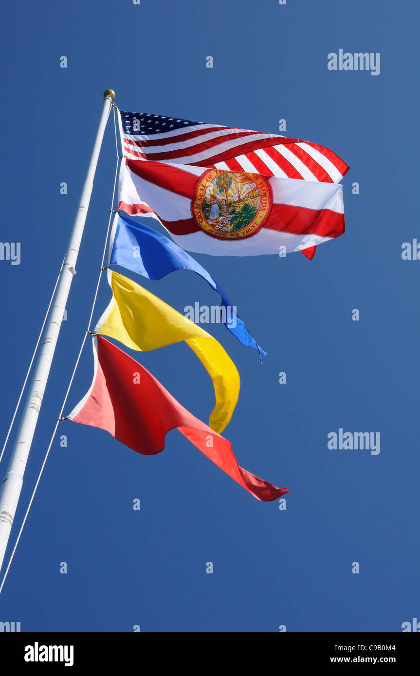 American flags flying from a flagpole against a blue sky Stock Photo ...