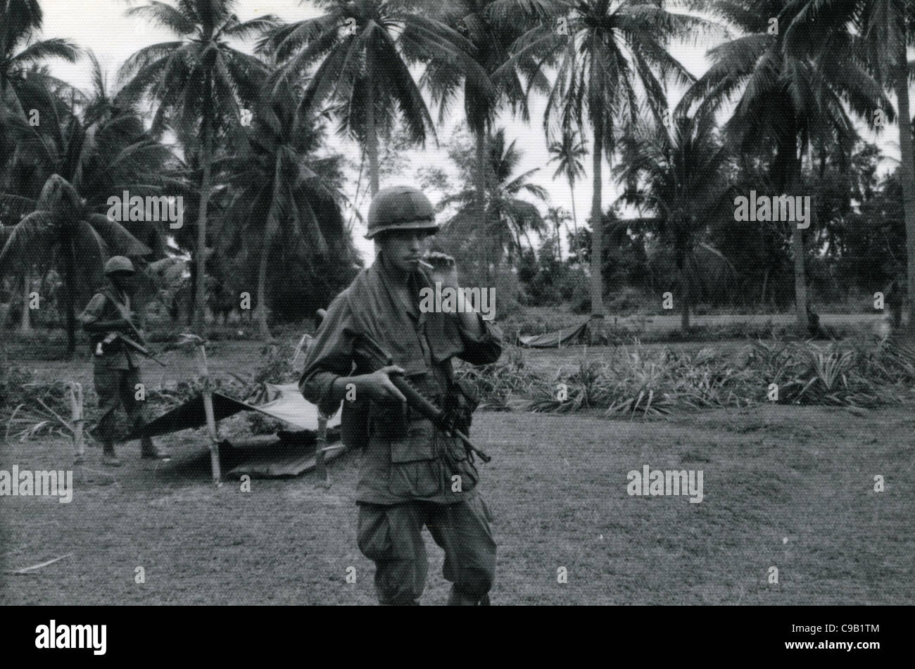 GI smoking cigarette, holding M16 on patrol. 101st ABN in the Ashau Valley  during the Vietnam War Stock Photo