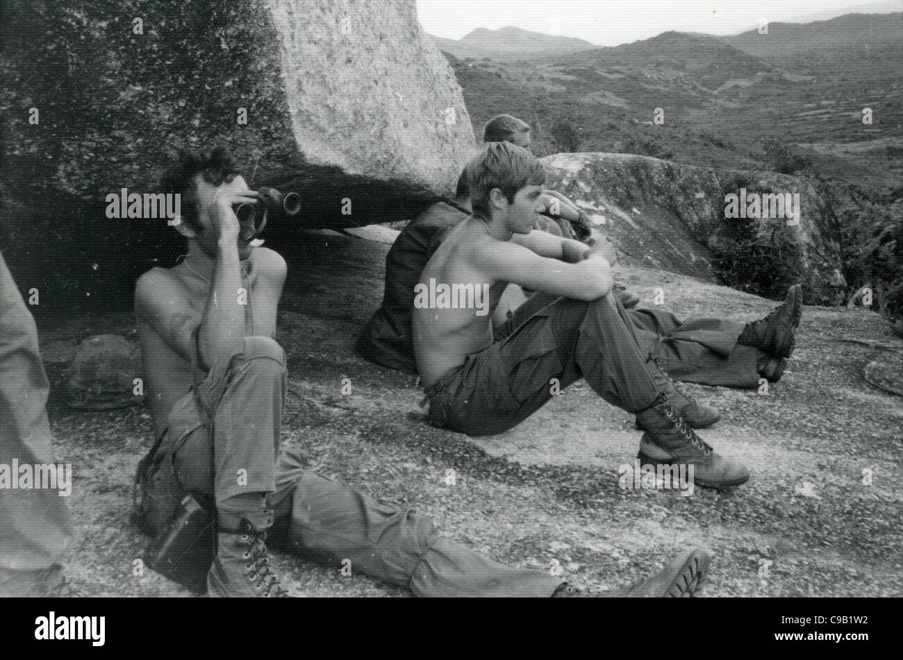 American soldiers looking over valley with binoculars. 101st ABN in the Ashau Valley during the Vietnam War. Stock Photo