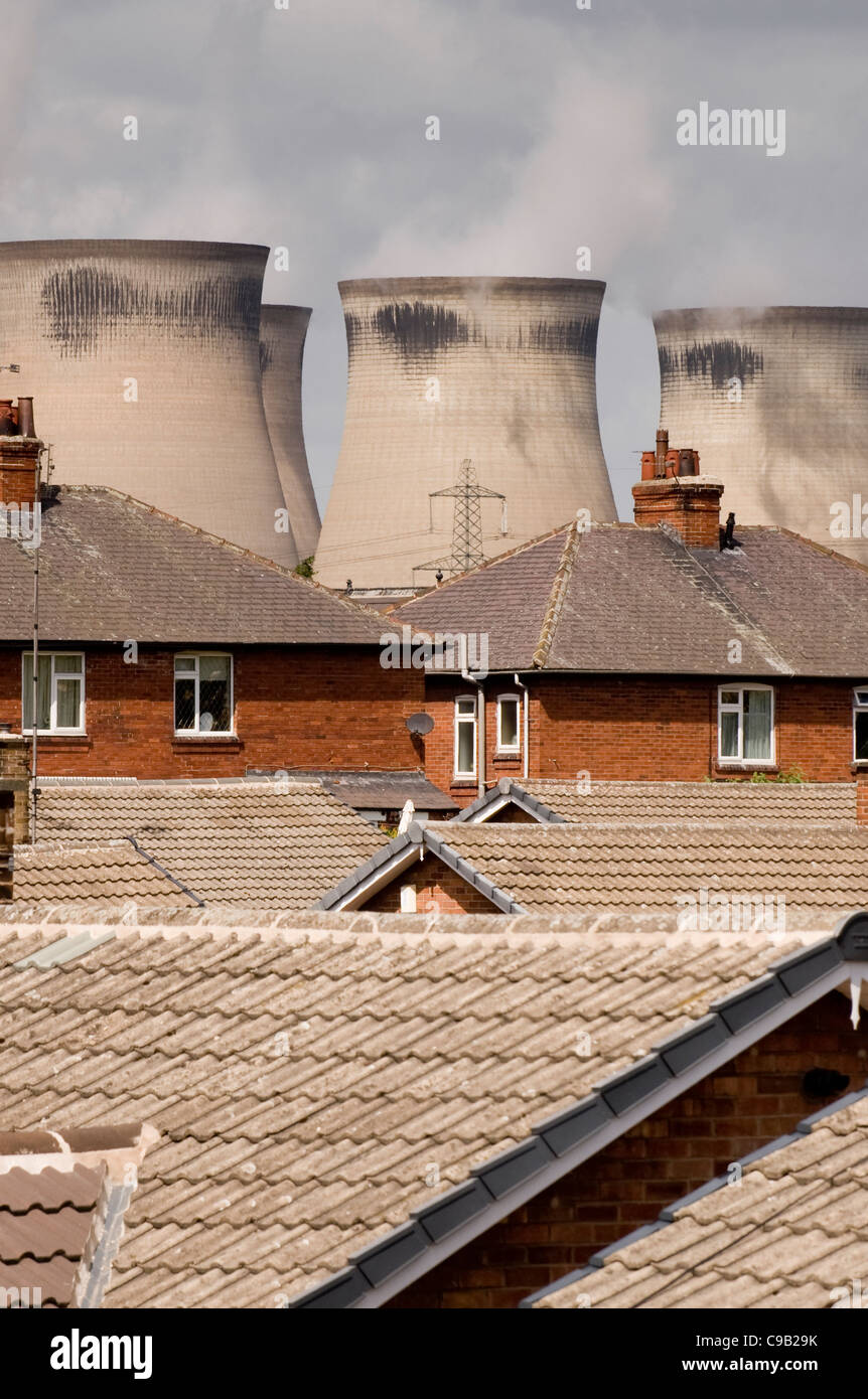Residential & industrial buildings - houses overshadowed by high cooling towers - Ferrybridge 'C' Power Station, Knottingley, Yorkshire, England, UK. Stock Photo