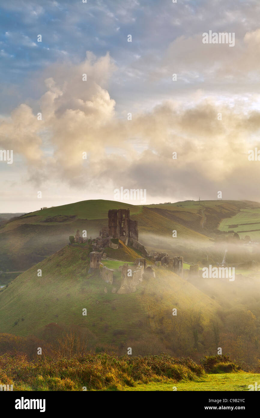 Corfe castle rising through the early morning mist Stock Photo - Alamy