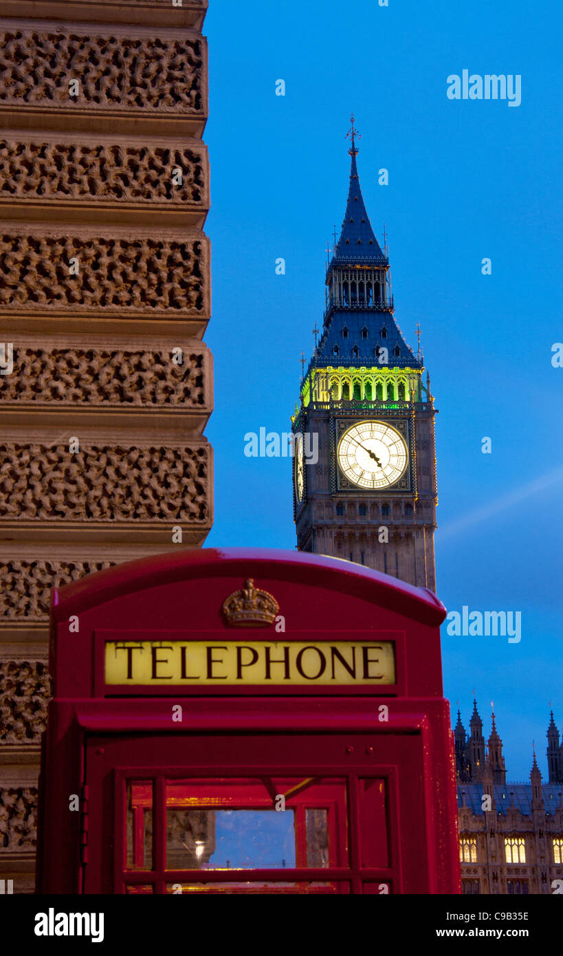 Traditional red telephone box and Big Ben Clock Tower of Houses of Parliament at night London England UK Stock Photo