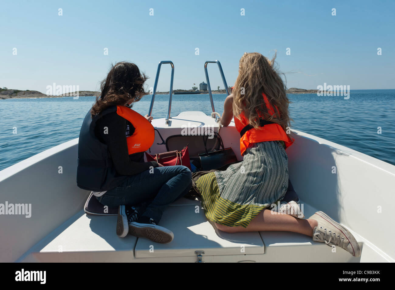 A couple of young women on a boat trip out to Kobba Klintar. Åland Finland Stock Photo