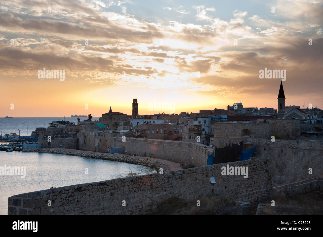 Steeples, domes, and minarets puncutate the Akko (Acre), Israel, skyline at sunset. Stock Photo