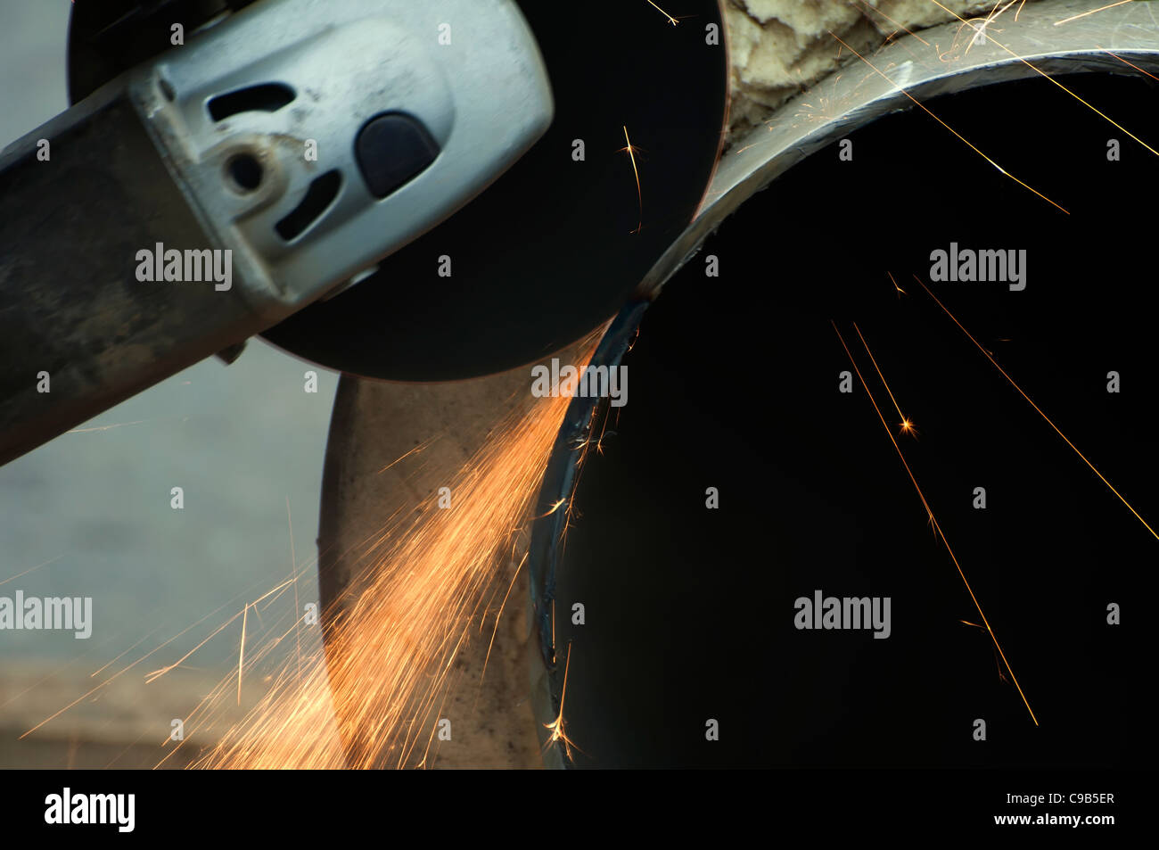 Cutting of pipes with grinder. Hot water and steam heating pipe Stock