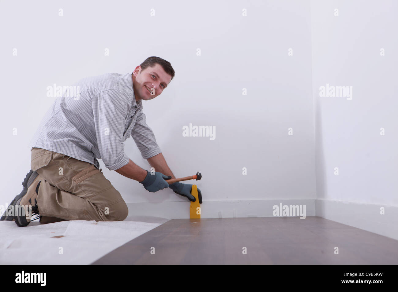 a man laying floorboards Stock Photo Alamy