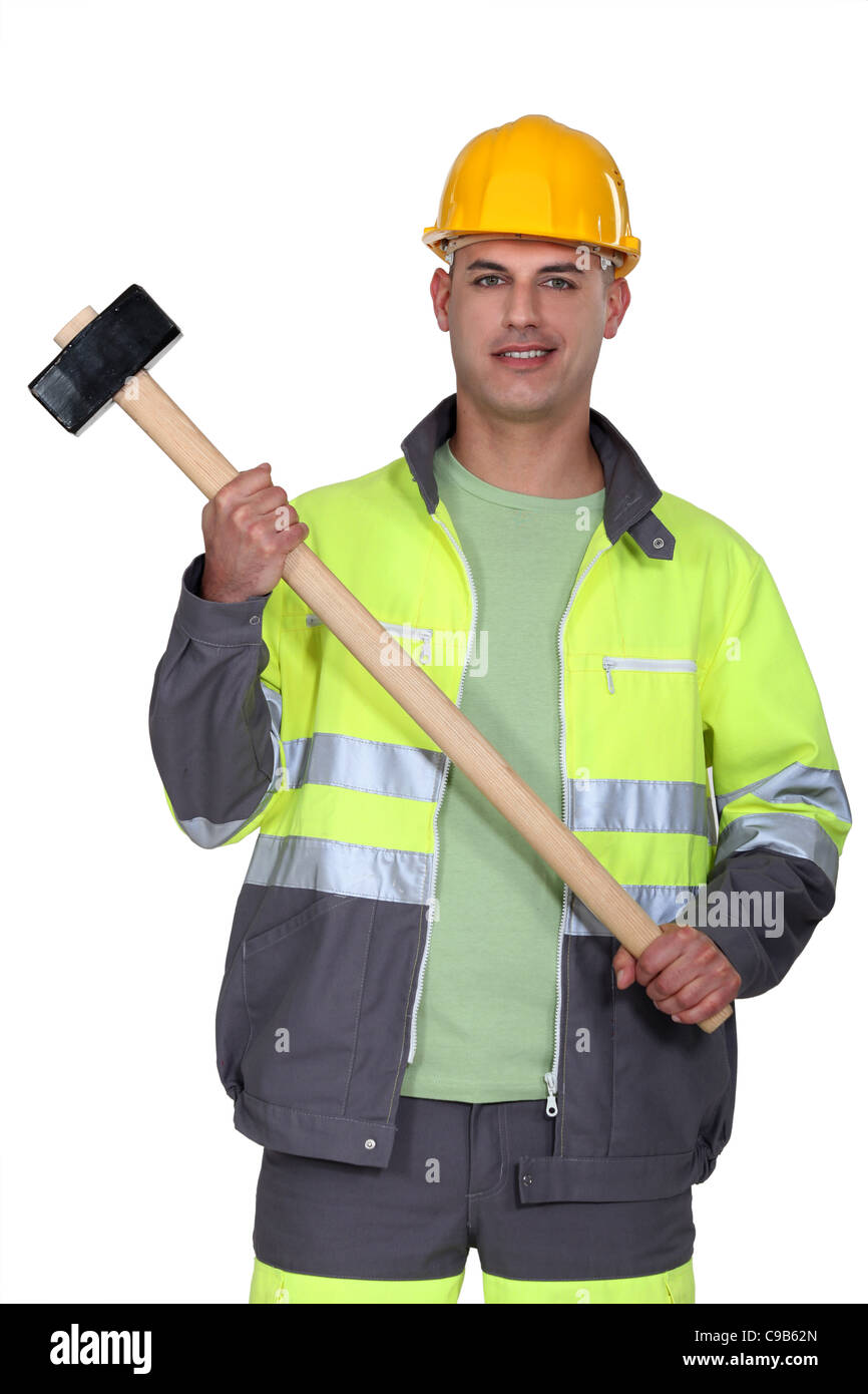 Builder holding sledgehammer Stock Photo Alamy