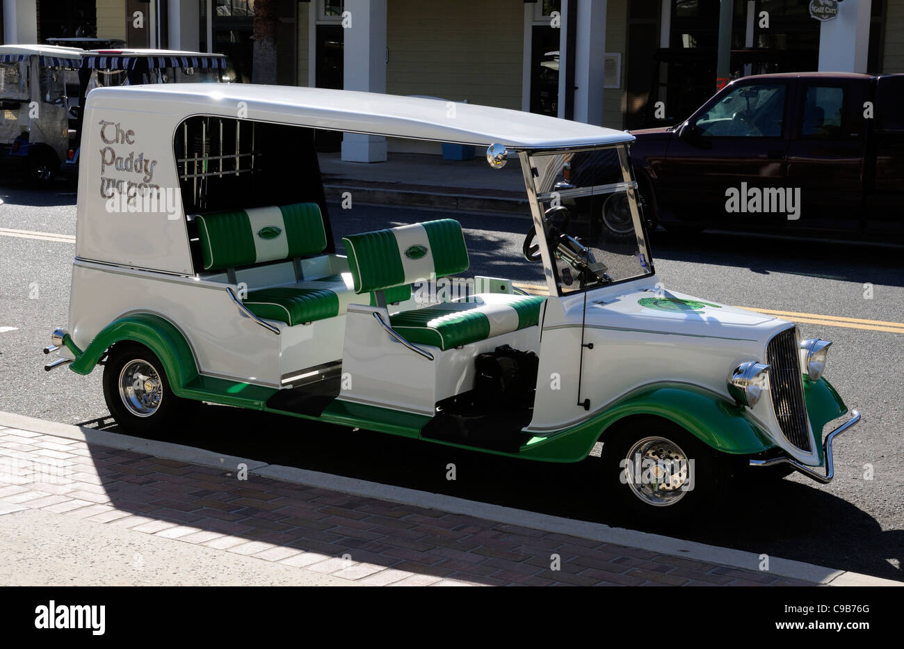 The Paddy Wagon a stretched golf cart parked on the roadside in Sumter Landing The Villages Florida Stock Photo