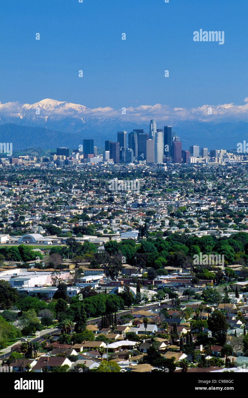 The impressive skyline of downtown Los Angeles stands out against the snowtopped San Gabriel