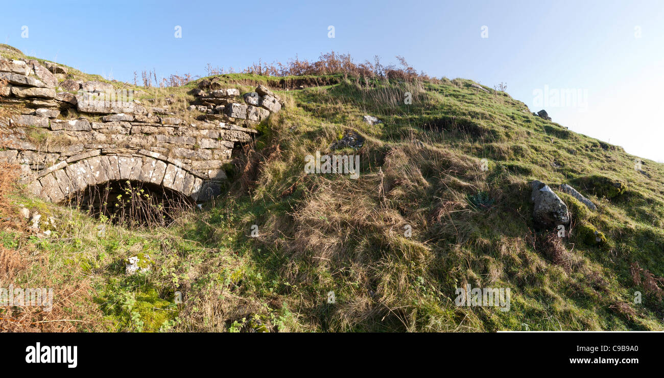 Panorama of the remains of a lime kiln set into escarpment bank, Cumbria, England Stock Photo