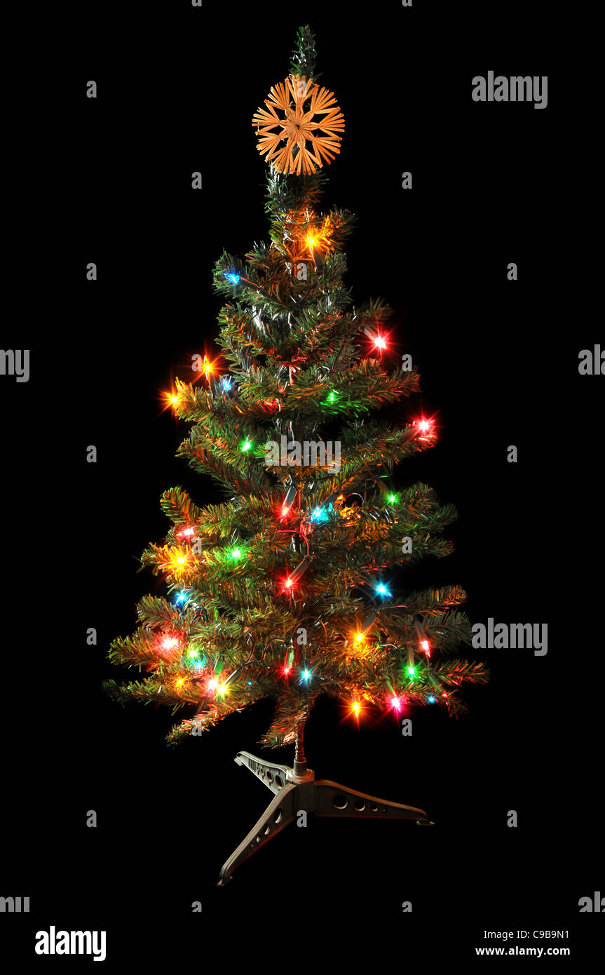 Decorated Christmas tree isolated on black background. Stock Photo