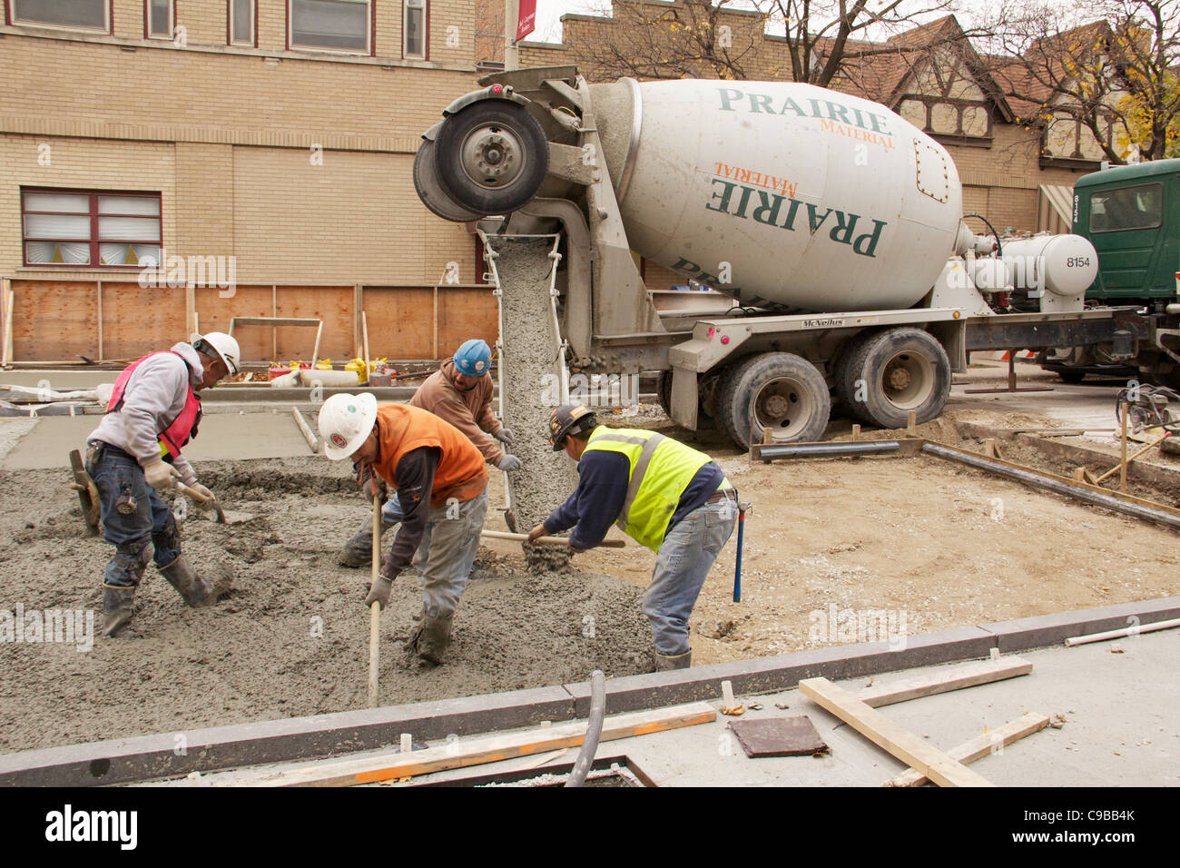 Construction workers pour concrete during Marion Street reconstruction
