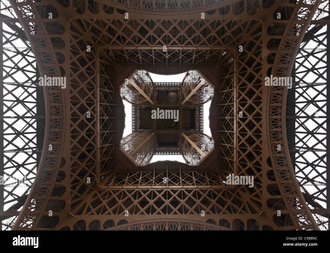 Ventral view of the Eiffel tower looking up through the ironworks Stock Photo