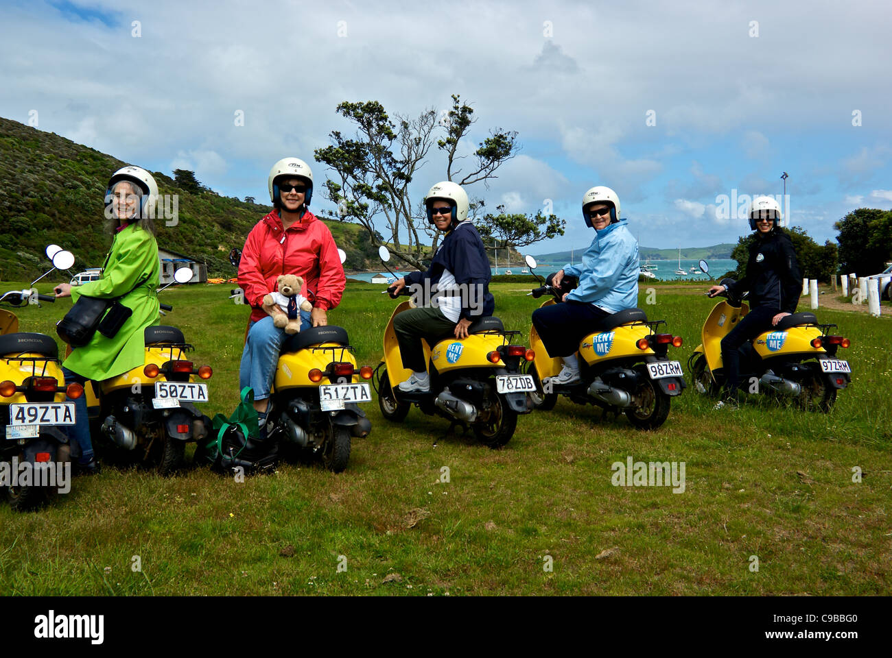 Group women tourists on Honda rental motor scooters on Waiheke Island