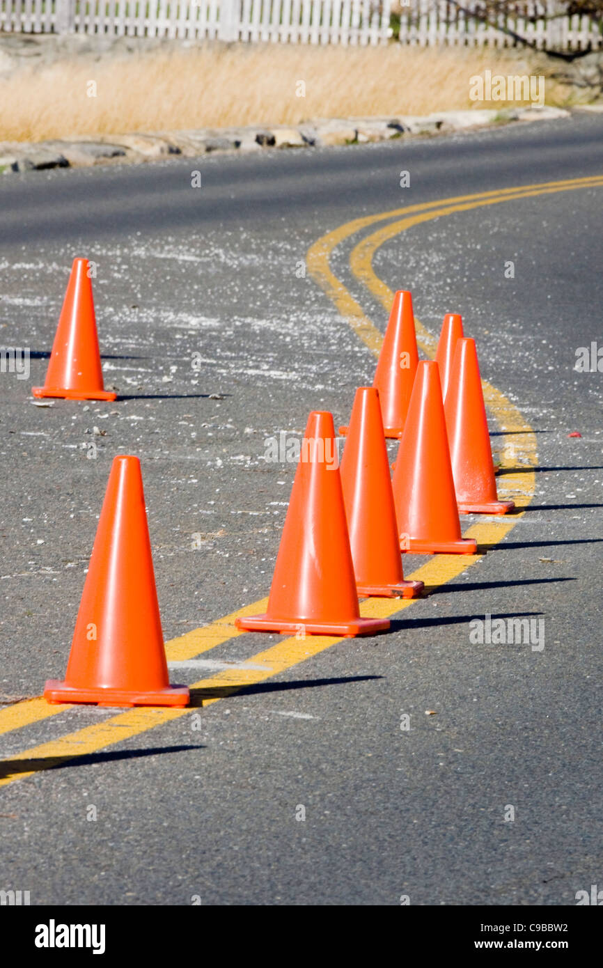 Traffic Cones on Double Yellow lines on a beach road in Connecticut USA Stock Photo