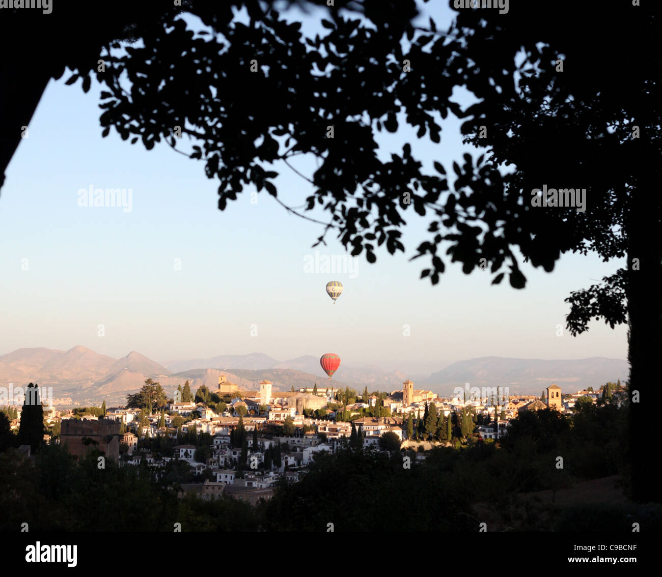 Hot air balloons pictured atdawn flying over the city of Granada in Andalucia, Spain Stock Photo