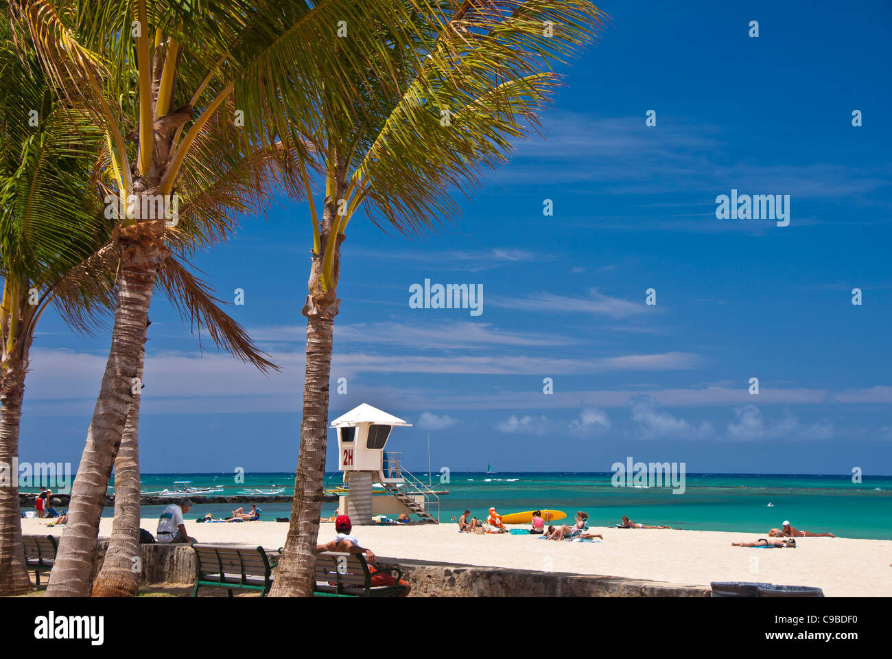 Waikiki Beach, Hawaii lifeguard stand, sunbathers, palm trees Stock Photo