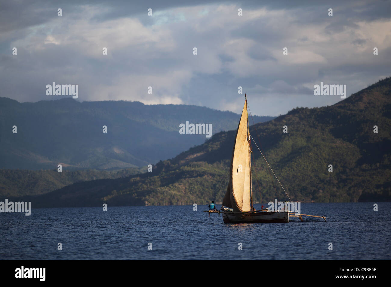 A traditional malagasy sailing vessel cruises the waters around Mamoko island, Madagascar Stock Photo