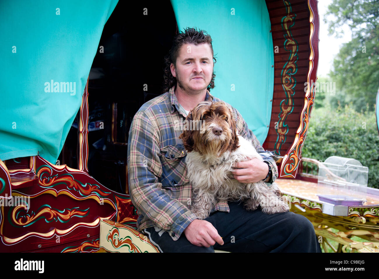 Traveler with dog and Romany caravan Stock Photo