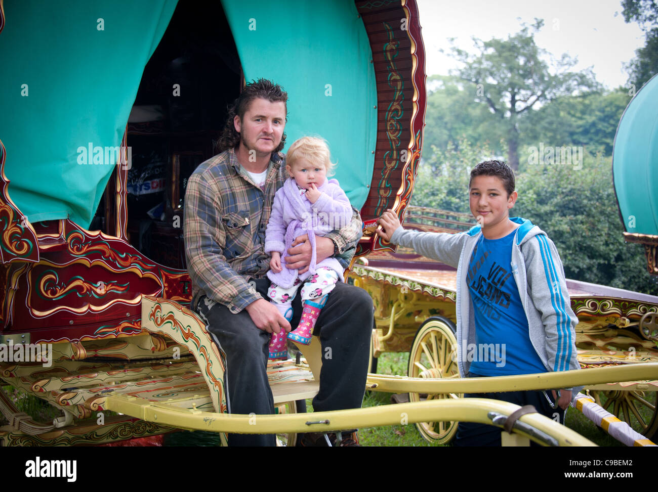 Traveler with Son and Daughter and Romany caravan Stock Photo