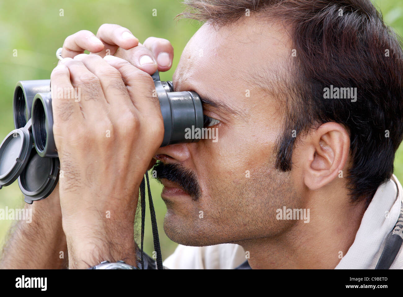 Naturalist,binocular,observing,nature,concentrating,Indian,man,'nature lover',birder,'bird-watcher','bird-watching',man,Indian, Stock Photo
