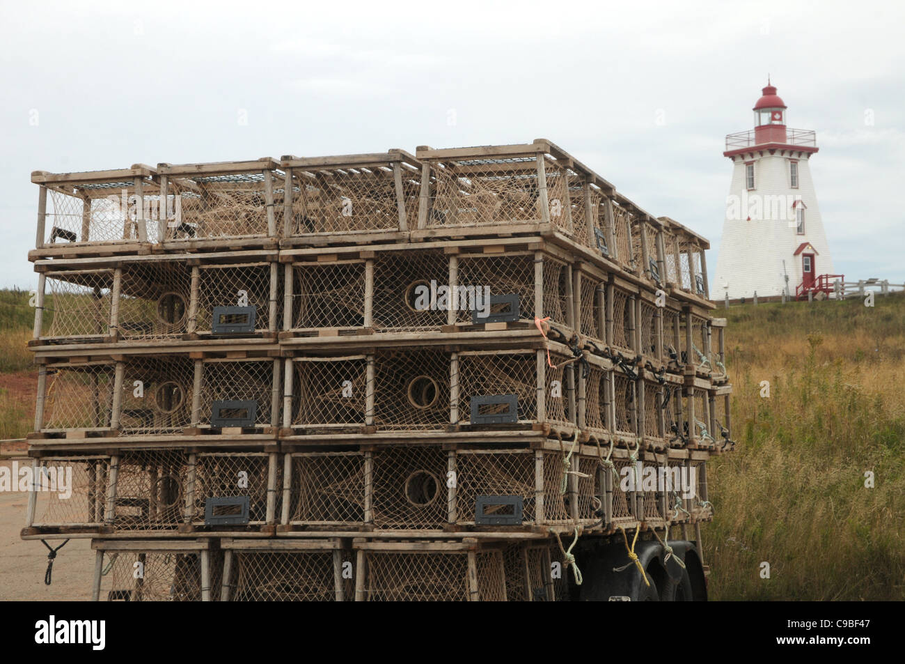 Lobster traps are grounded in front of a lighthouse in Souris, Prince