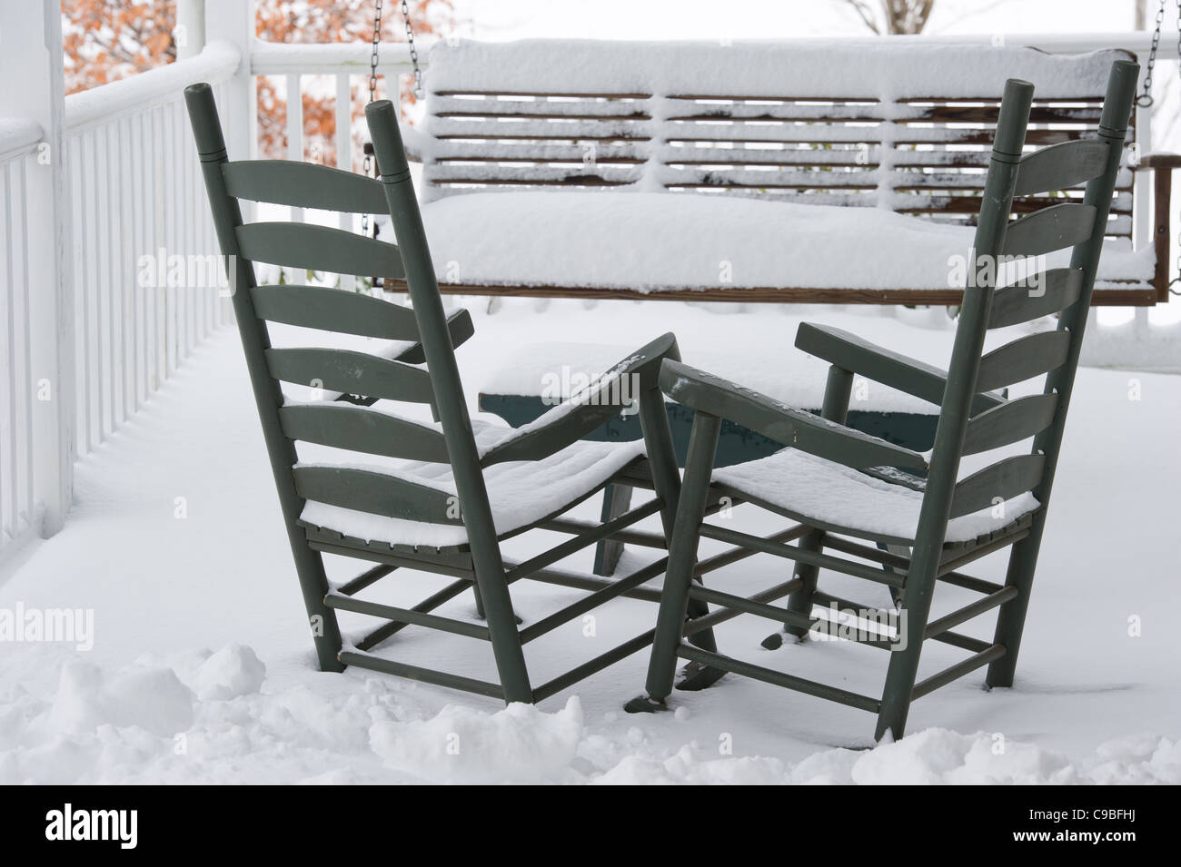 Snow covered table and chairs on a porch Stock Photo