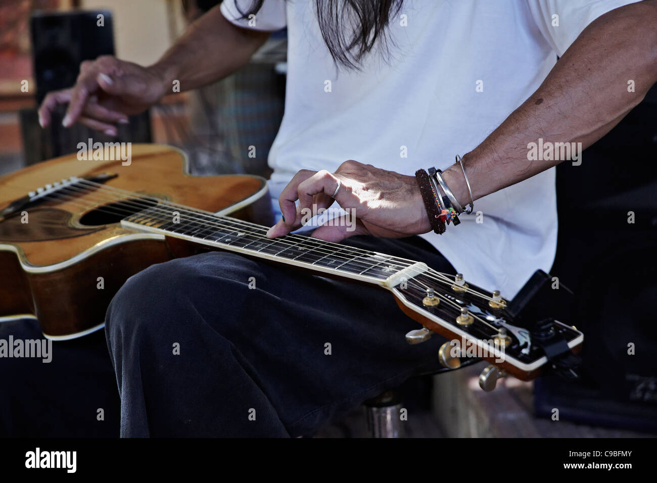 Guitar player. Close up of an acoustic guitar using an unusual "tapping