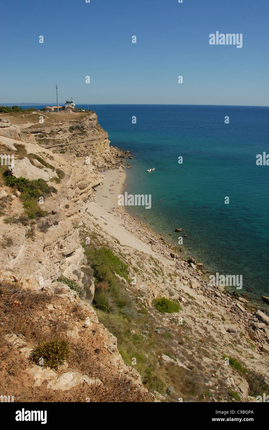 The chalky cliffs of Cap Leucate on the Golfe du Lion of the Mediterranean Sea with lighthouse and rocky sand beach Stock Photo