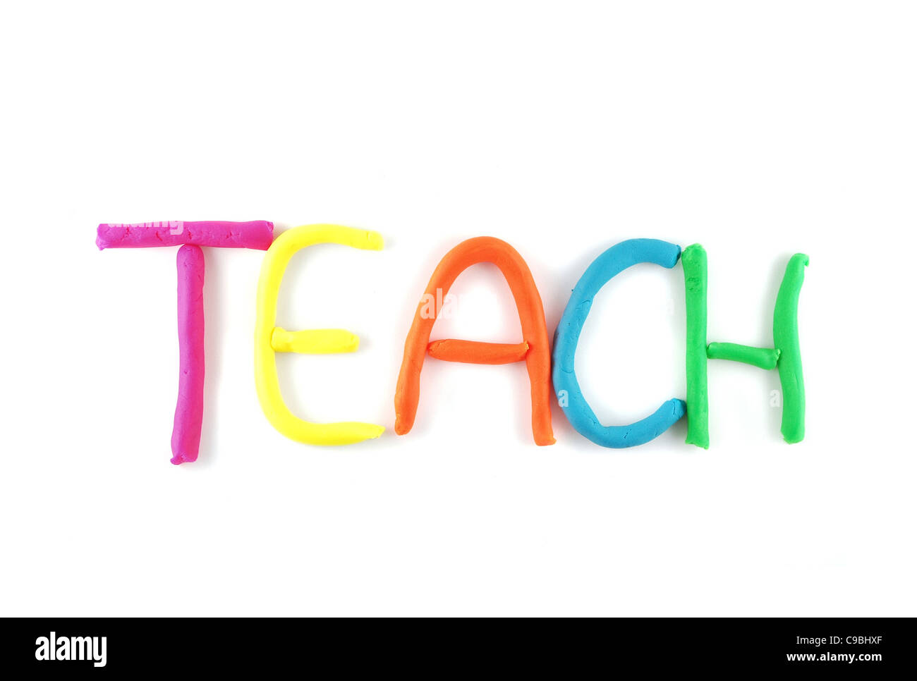'Teach' spelled out using child's clay isolated on a white background Stock Photo