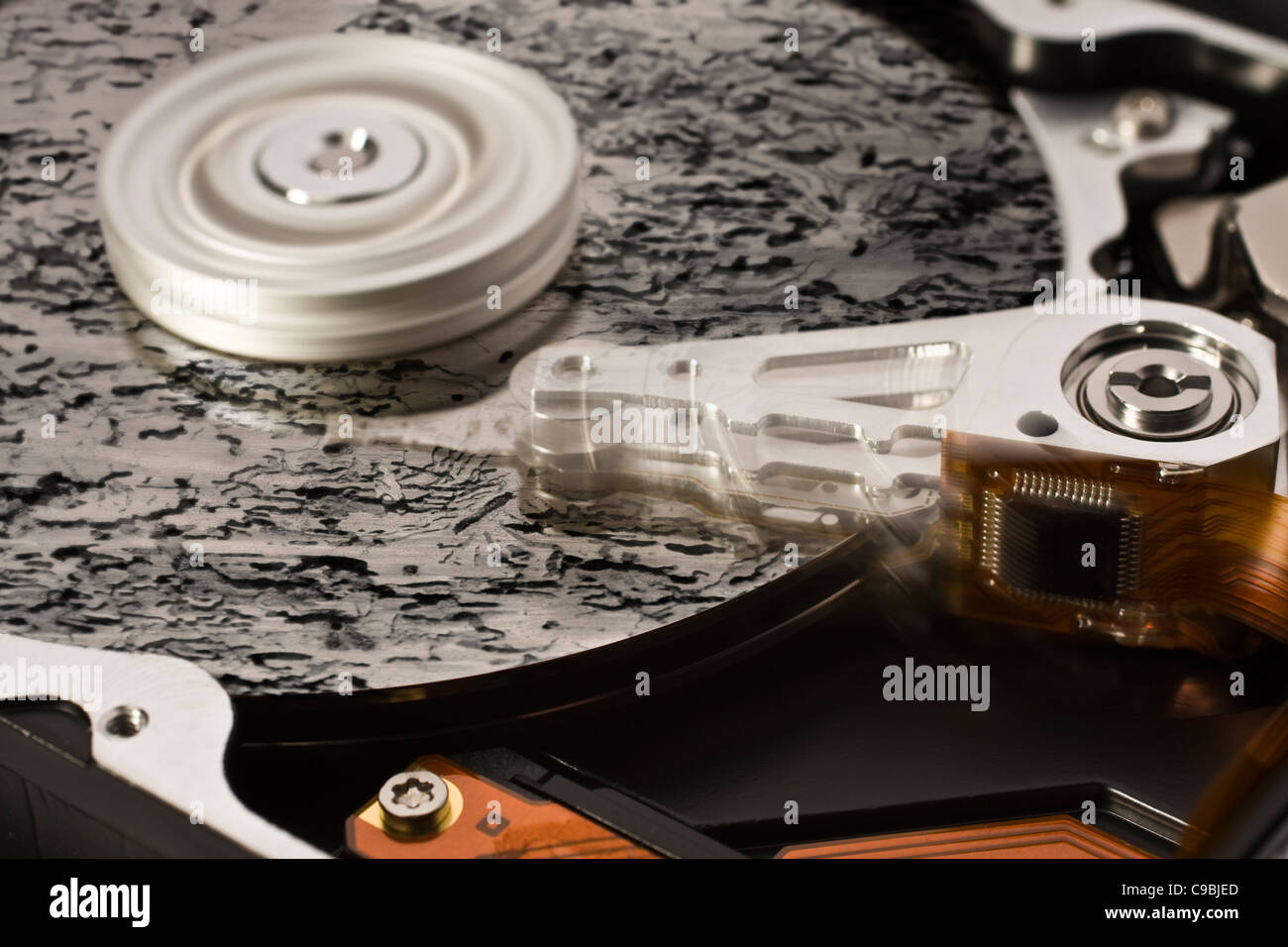 symbolic data loss theme showing a open hard disk with symbolic rotten data Stock Photo