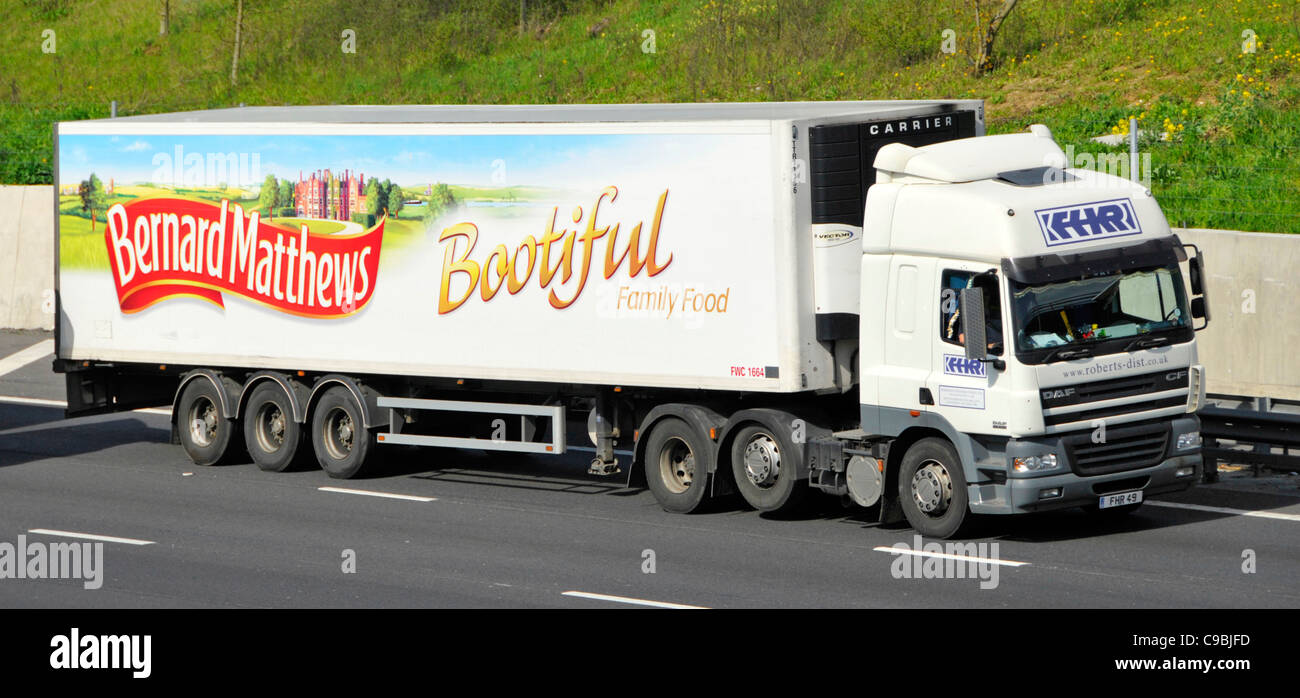 DAF CF hgv lorry truck & Bernard Matthews name side of articulated trailer advertising Bootiful poultry business he founded driving on UK M25 motorway Stock Photo