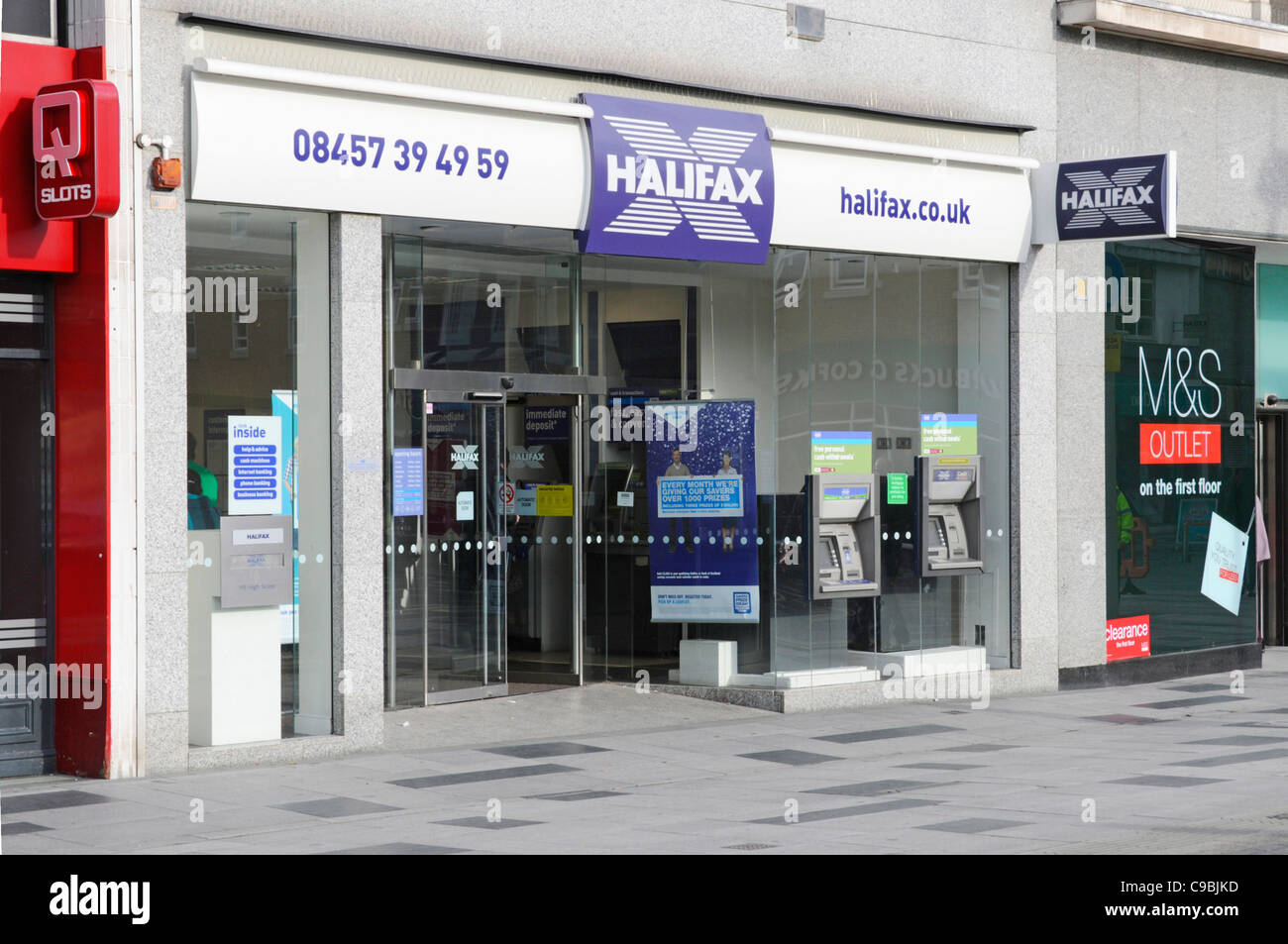 Slough High Street branch premises shop front of Halifax Bank with phone number & internet contact data two ATM cash machines Berkshire England UK Stock Photo
