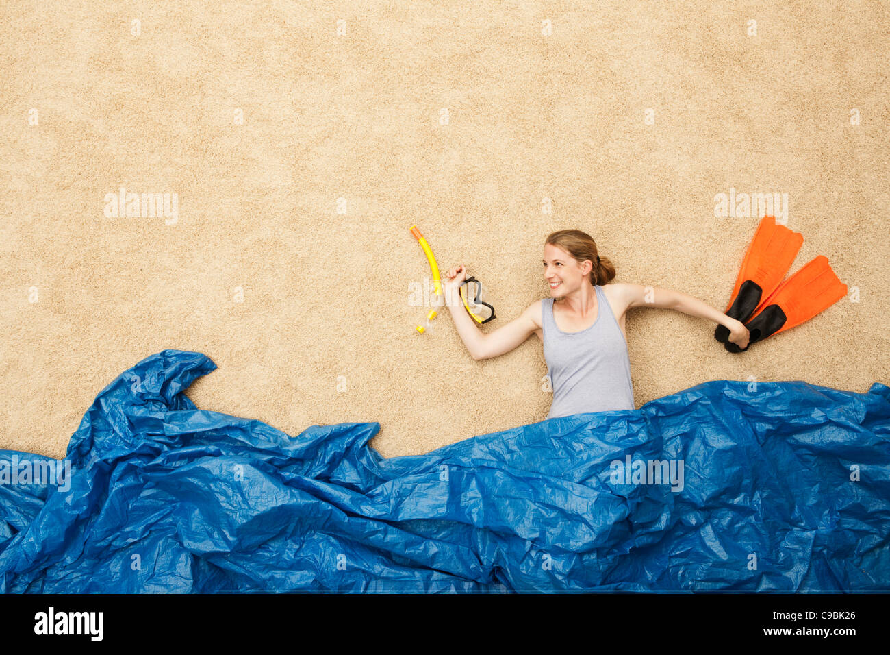 Germany, Young woman snorkling equipemts in water Stock Photo