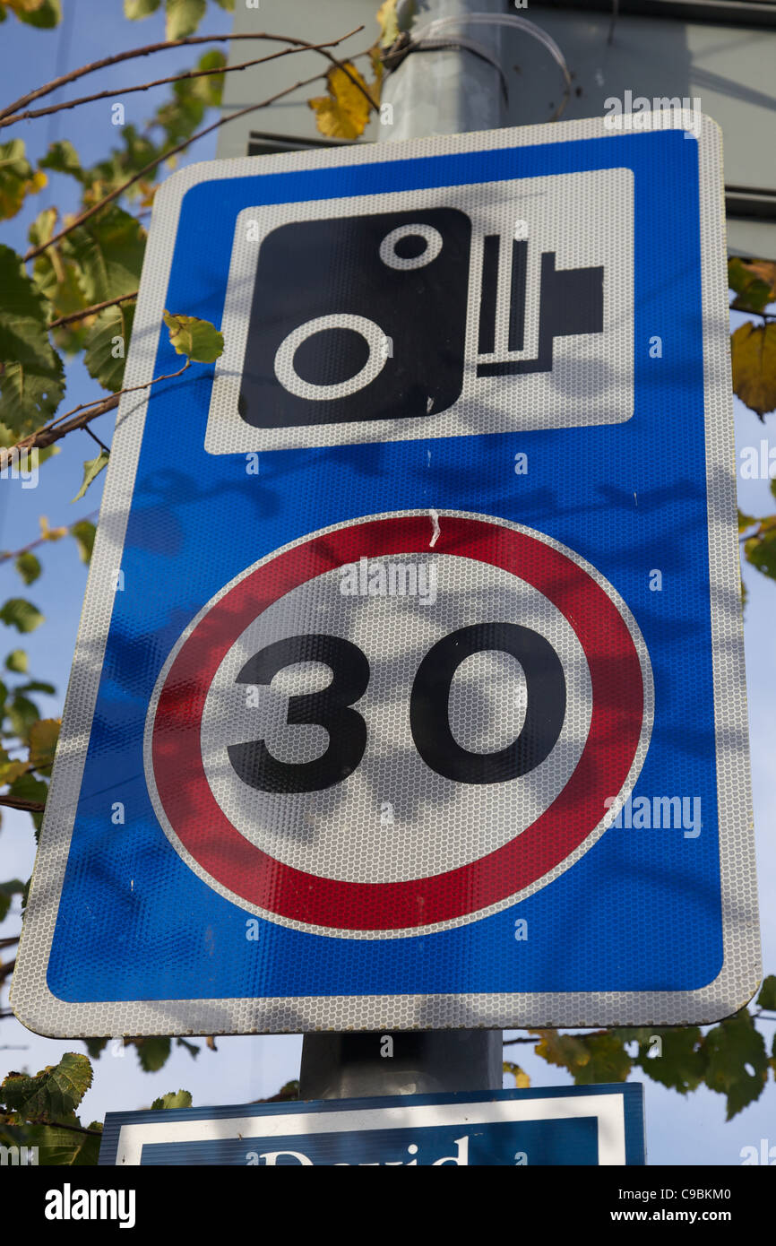 A speed limit and speed camera sign in England Stock Photo