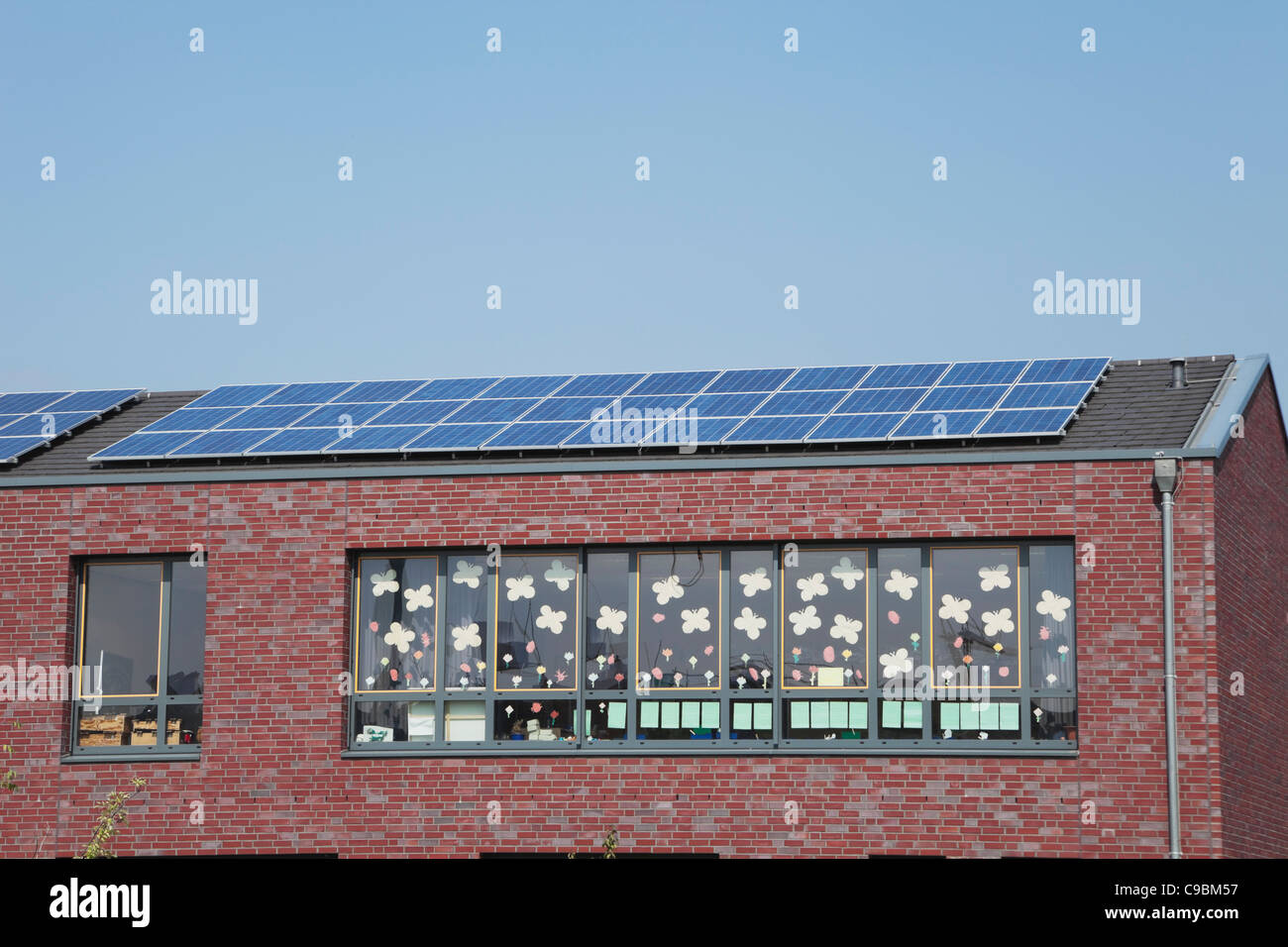 Germany, Cologne, Roof of school building with solar panels Stock Photo