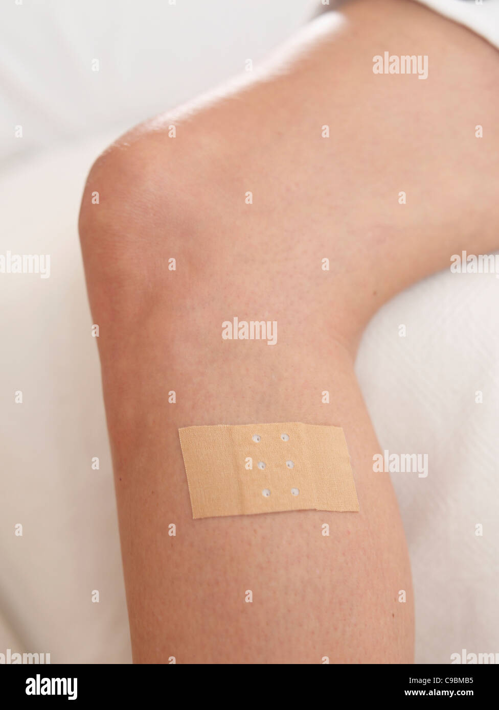 Human leg with band aid, close up Stock Photo