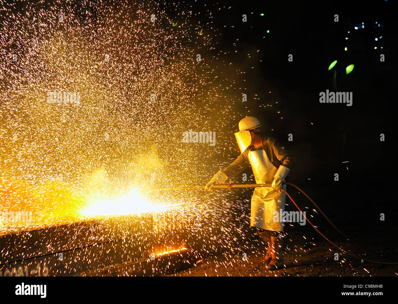 worker using torch cutter to cut through metal Stock Photo Alamy