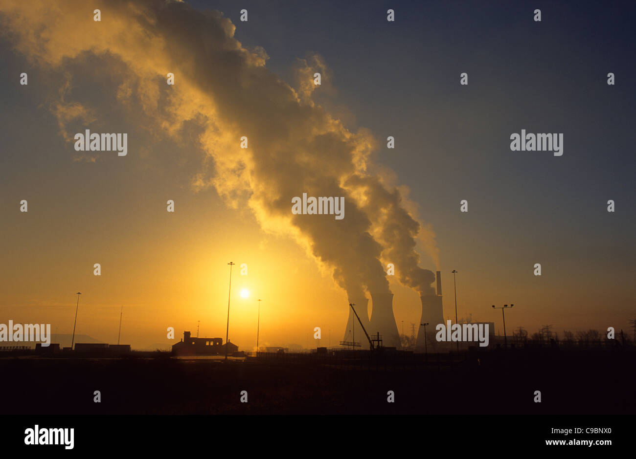 steam rising from coal powered power station near Leeds at sunrise yorkshire uk Stock Photo