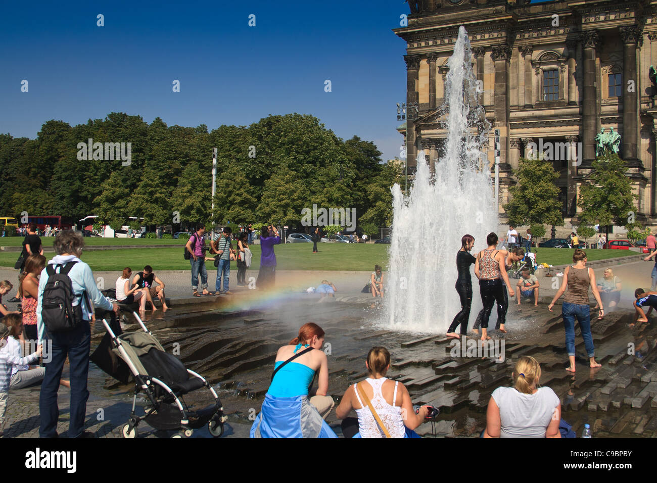 People cooling off in fountain outside the Altes Museum. Berlin, Germany. Stock Photo