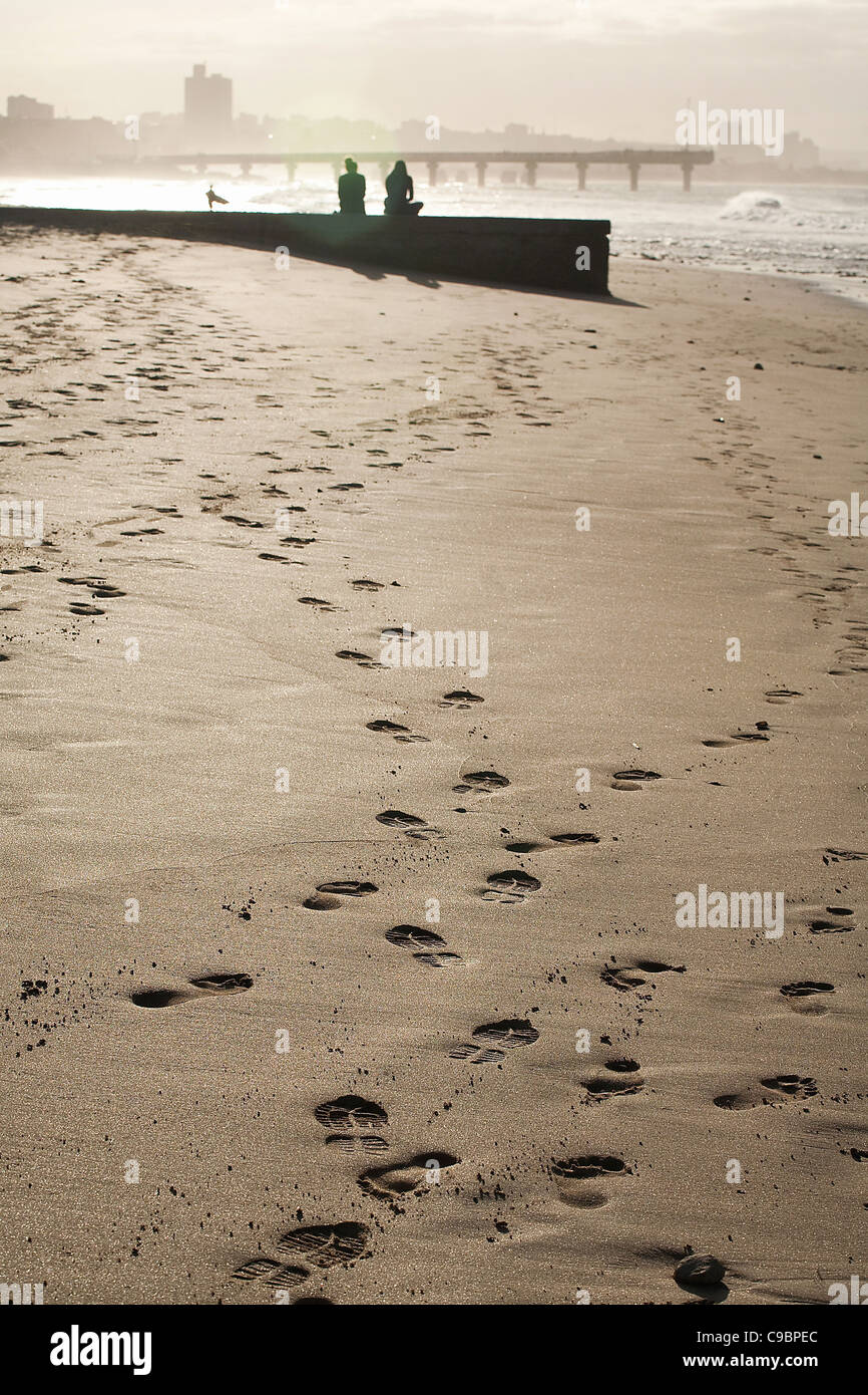 Footsteps in the sand on the beach Stock Photo