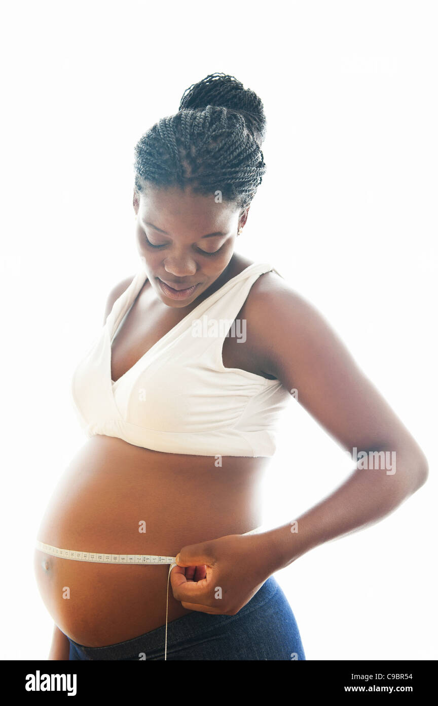 Pregnant woman measuring size of her stomach, Johannesburg, Gauteng Province, South Africa Stock Photo