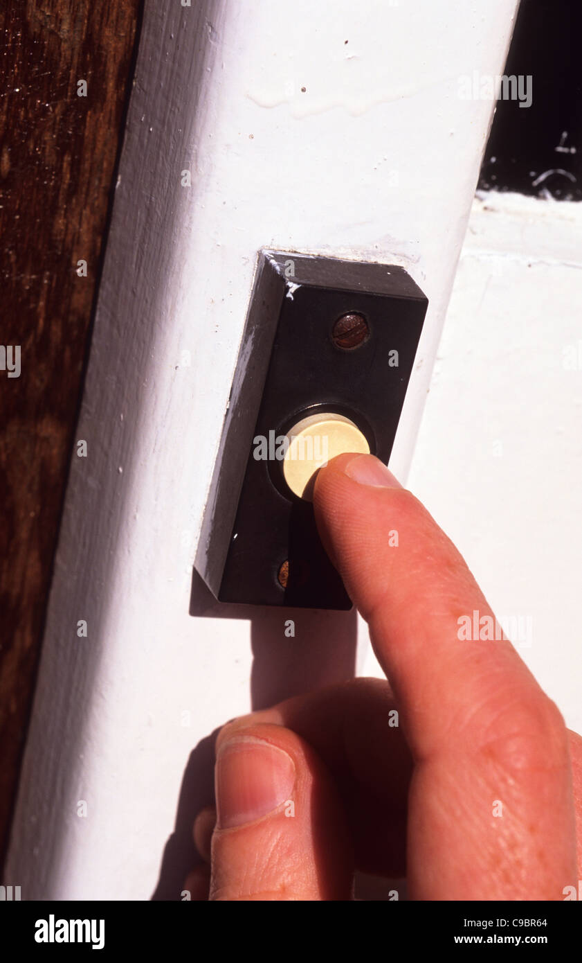 person pressing house doorbell Stock Photo