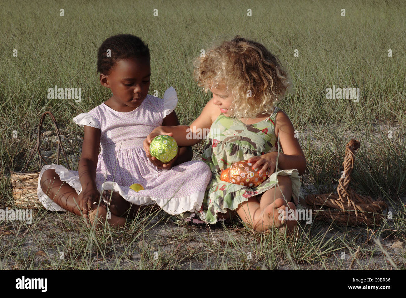 Two young girls playing with Easter Eggs, Grabouw, Cape Town, Western