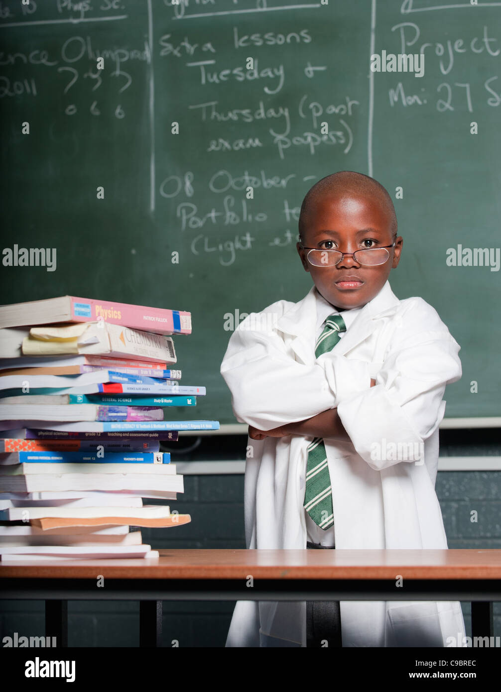 Portrait of boy wearing lab coat in classroom, Johannesburg, Gauteng