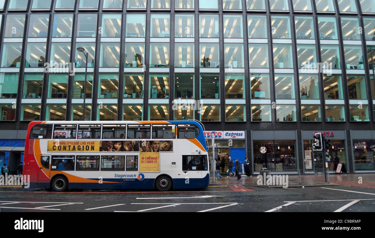The film Contagion advertised on the side of a double-decker bus on a street in Central Manchester, England, UK Stock Photo