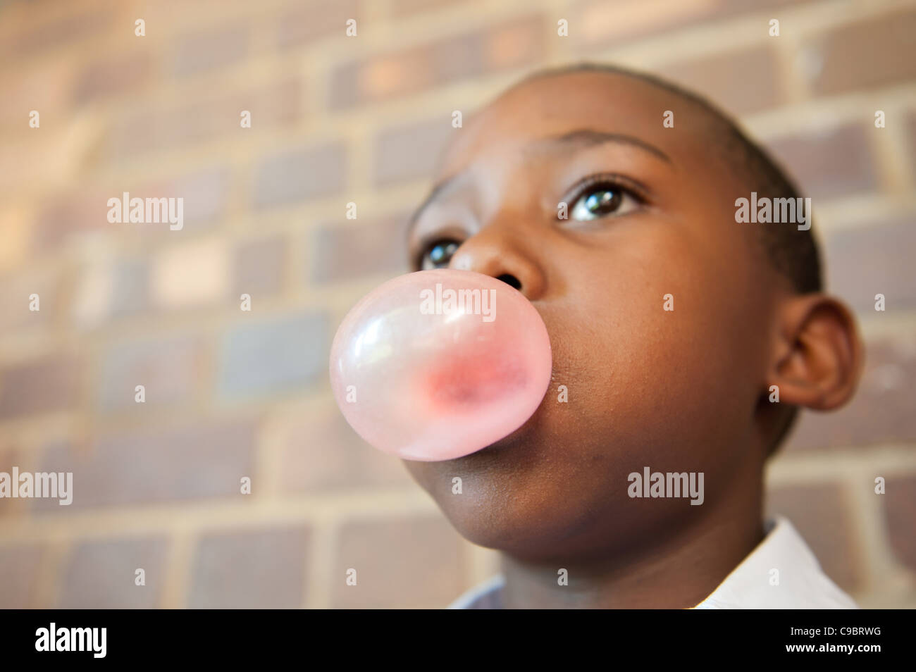 Boy blowing bubble with chewing gum, Johannesburg, Gauteng Province, South Africa Stock Photo